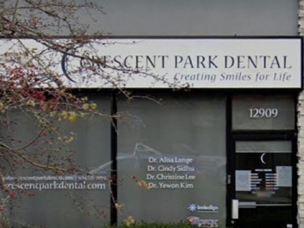 Signage for Crescent Park Dental is displayed prominently on a storefront, featuring the tagline "Creating Smiles for Life." The address, 12009, is visible, along with the names of the dental professionals associated with the practice.