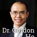 A smiling man wearing glasses, dressed in a formal suit with a bow tie, represents Dr. Gordon He. The image conveys a professional and approachable demeanor.