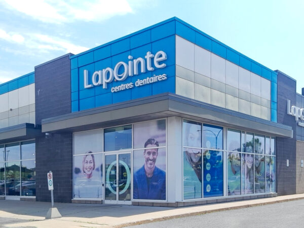 A dental clinic named Lapointe is showcased, featuring a blue exterior and large windows displaying smiling patient images. The bright and inviting atmosphere emphasizes dental care services.