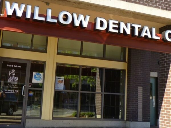 The front entrance of Willow Dental Care, featuring large windows and a sign above the door.